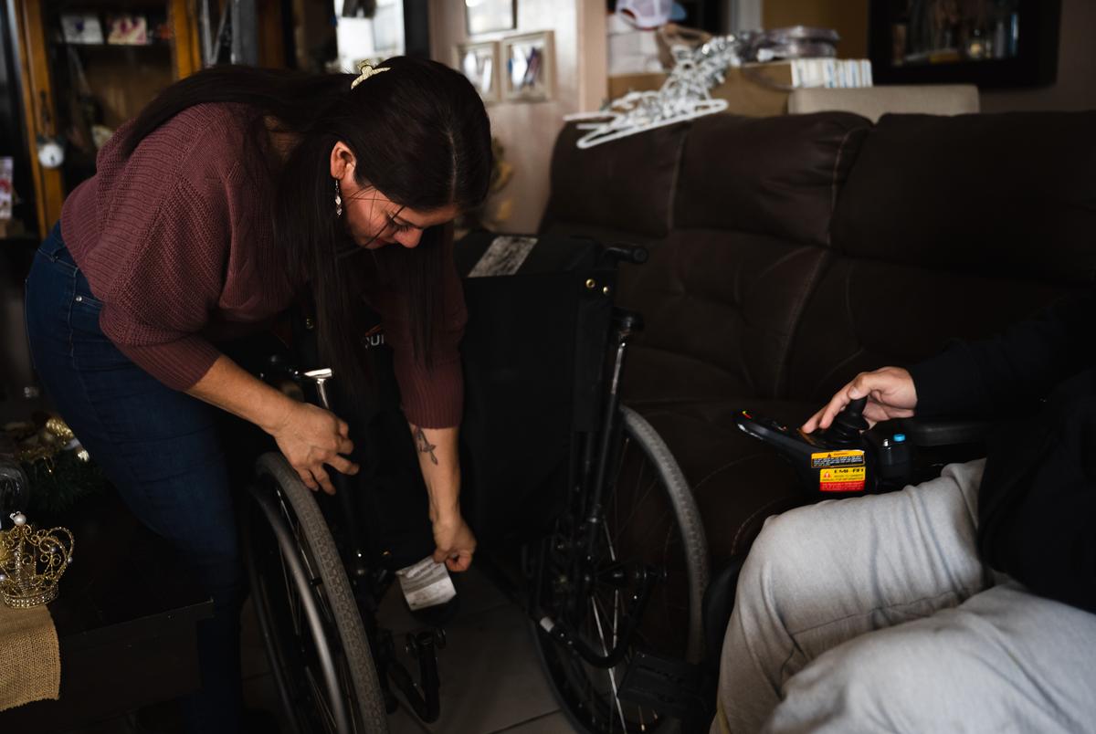 Juvencia Padilla shows a mismatched backrest on her son Tino’s wheelchair. They have fought for his medical equipment provider to repair his wheelchair for months, in the meantime more parts have broken. Fort Hancock, Texas. November 28, 2023.